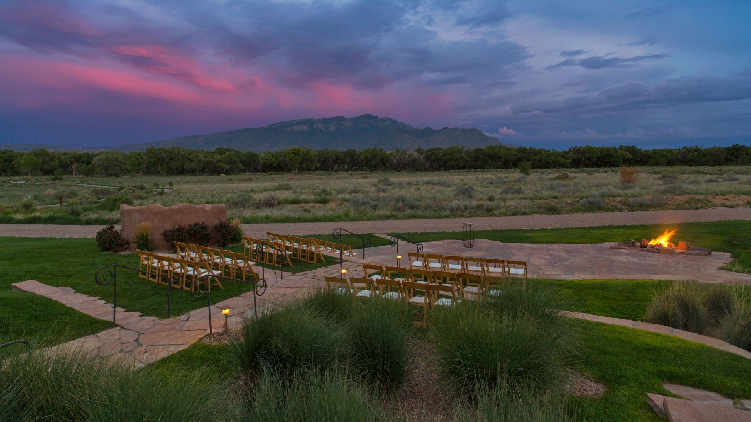 Real sunset wedding ceremony setup at Hyatt Regency Tamaya with the Sandia Mountains in the background
